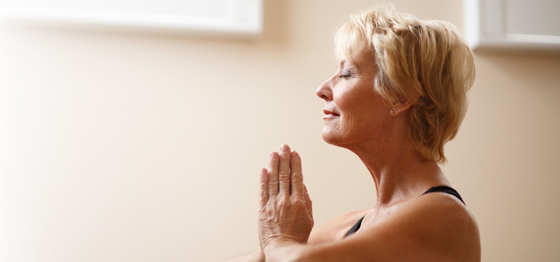 older woman doing a yoga pose