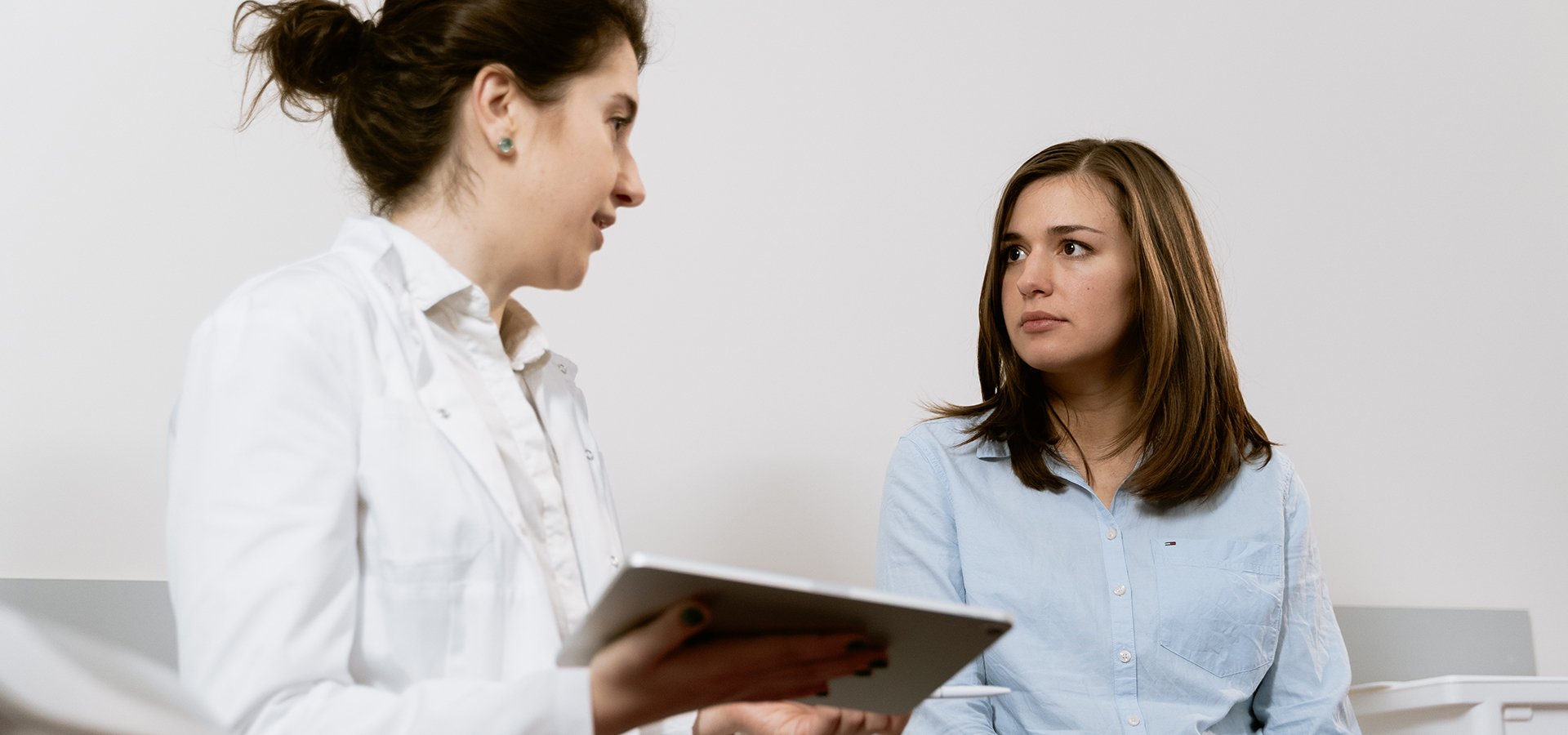 a doctor talking with a patient in an exam room